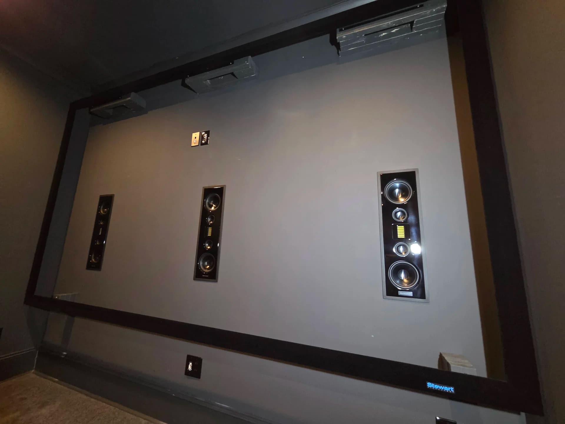 Acoustically transparent frame mounted, revealing the speaker array behind the screen
